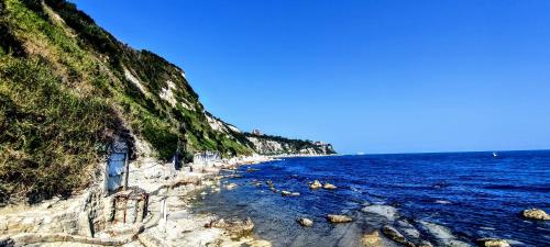 a beach next to the ocean on a cliff at Vivi Conero in Ancona