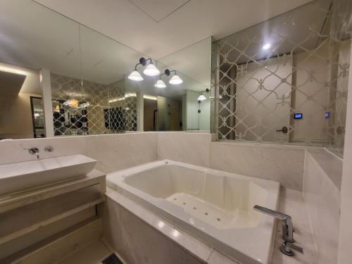 a bathroom with a sink and a large mirror at Hotel Cullinan Wangsimni in Seoul