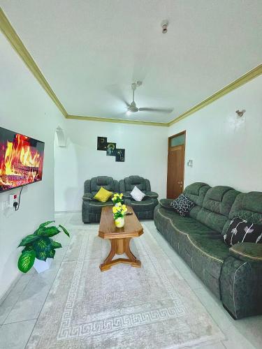 a living room with a couch and a table at Ngoki’s comfort apartment in Mombasa