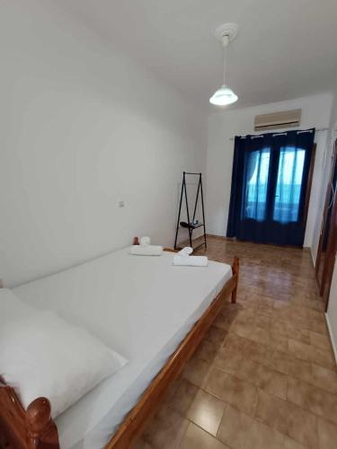 a bedroom with a large white bed in a room at Nisaki chios apartments in Agia Ermioni