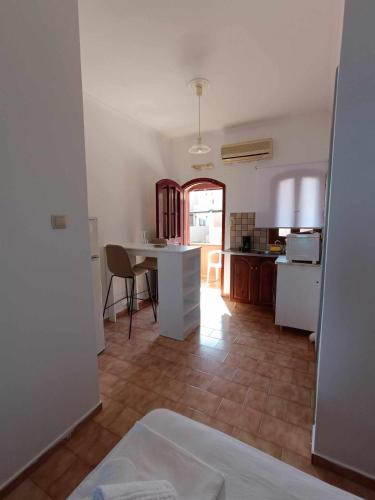 a kitchen and dining room with a table and a counter at Nisaki chios apartments in Agia Ermioni