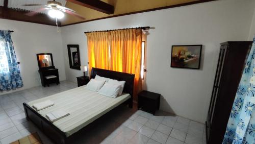 a bedroom with a bed and a window at Bluewaves Resort - Basdaku by Hiverooms in Moalboal