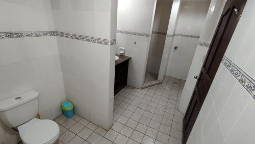 a small bathroom with a toilet and a shower at Bluewaves Resort - Basdaku by Hiverooms in Moalboal