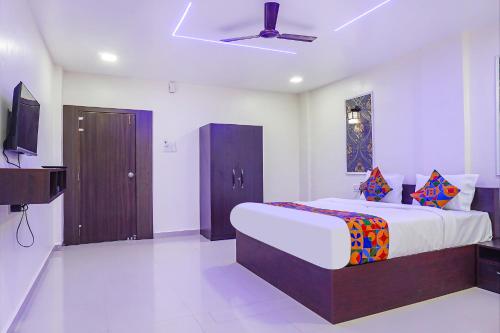 sypialnia z dużym łóżkiem i telewizorem z płaskim ekranem w obiekcie FabHotel Atharva Executive w mieście Pune