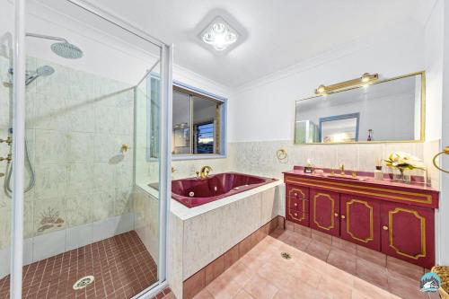 a bathroom with a red sink and a shower at Aircabin - Woy Woy - Water Front - 6 Beds Lux Home in Daleys Point