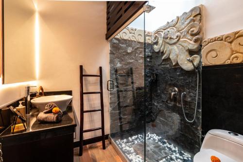 a bathroom with a shower and a sink at PROMO Stylish Spacious 3BD Villa in Kerobokan