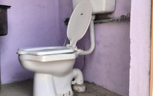 a white toilet with the lid up in a room at Namkha Camp and Restaurant by StayApart in Tabo