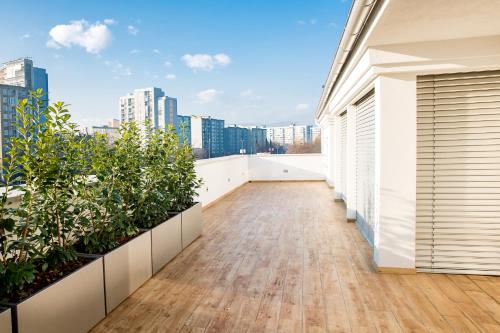 an empty balcony with plants on a building at WH Apartments in Ljubljana