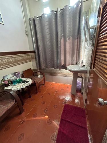 a bathroom with a table and a sink and a shower at Baan Are Gong Riverside Homestay in Phra Nakhon Si Ayutthaya