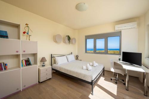 a bedroom with a bed and a desk and a computer at Villa Zafira - Seaview Manor with Heated Pool in Kallithea Rhodes