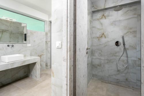a bathroom with a shower and a sink at Villa Zafira - Seaview Manor with Heated Pool in Kallithea Rhodes