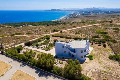 an aerial view of a house with the ocean in the background at Villa Zafira - Seaview Manor with Heated Pool in Kallithea Rhodes