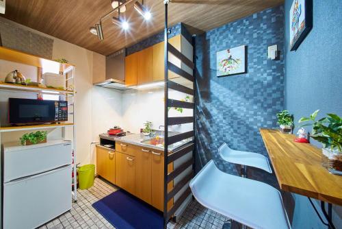 a small kitchen with a staircase in a tiny apartment at Shinjuku 102 Private Stay Near Park and Station with Free WiFi in Tokyo