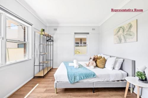 a bedroom with a bed with a teddy bear on it at Cozy Queen Room in Narwee - Next to Stations & Shops - Shared Bathroom in Riverwood