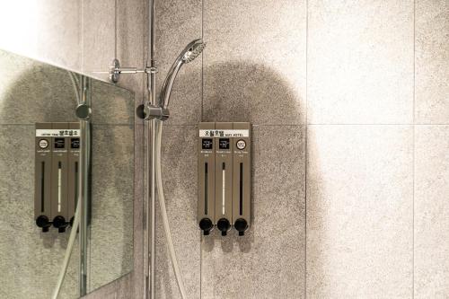 a shower in a bathroom with a glass door at Hotel May Yongsan in Seoul