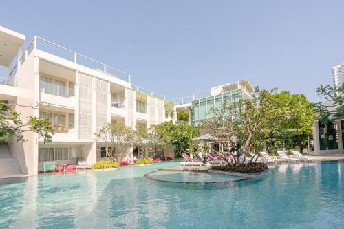 a swimming pool in front of a building at The Sea Cret Hua Hin in Hua Hin