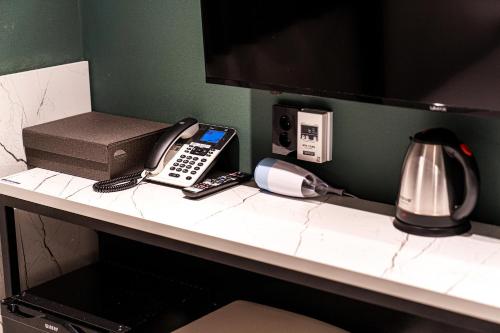 a desk with a phone and a coffee maker at Hotel May Yongsan in Seoul