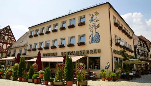 a large building with plants in front of it at Hotel Brauereigasthof Schwanenbräu in Ebermannstadt