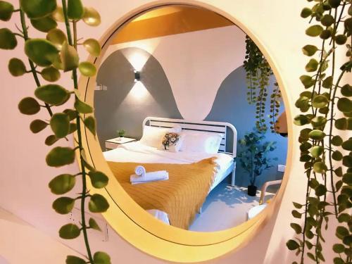 a bedroom with a bed in a round mirror at Area Bandar Putra Kulai 4-6BR near AEON IOI Airport in Kulai