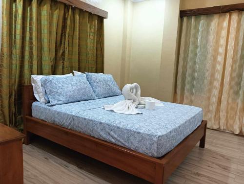 a bed with a swan sitting on top of it at Marietta's Hotel in Bajuyan