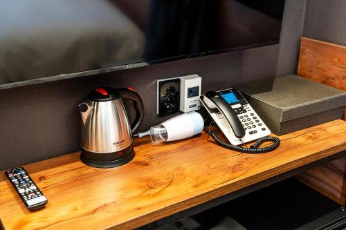 a table with a coffee maker and a phone on it at Hotel May Yongsan in Seoul