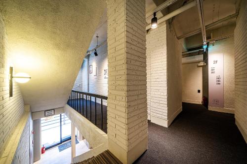 a hallway in a building with a brick wall at Hotel May Yongsan in Seoul