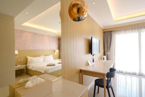 a hotel room with a bed and a desk at The Sea Cret Hua Hin in Hua Hin