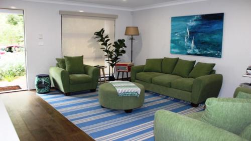 a living room with green couches and chairs at Pet Friendly With Privacy, Excellence & Wifi in Hawks Nest