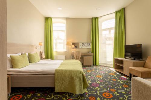 מיטה או מיטות בחדר ב-City Hotels Rūdninkai