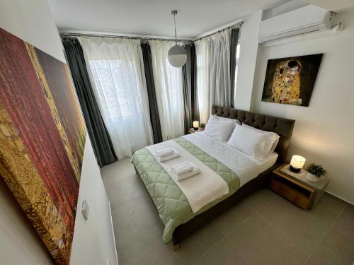 a bedroom with a bed with two towels on it at Kallithea Central Apartment in Kallithea Halkidikis