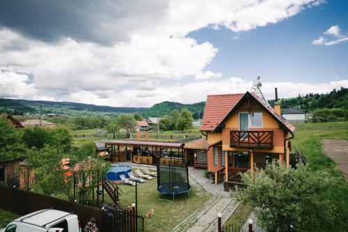 a house with a garden and a playground at Riverside • cabine in Gălăuţaş
