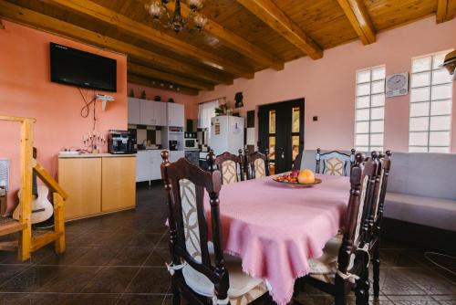 a dining room with a table and a kitchen at Riverside • cabine in Gălăuţaş