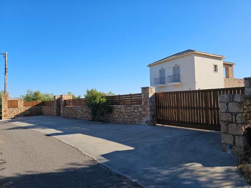 a driveway with a fence and a house at Villa Athina in Gythio