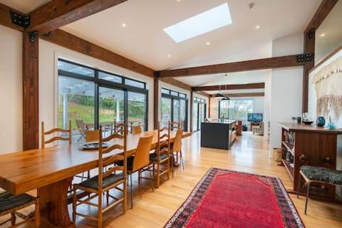 a large dining room with a table and chairs at Korepo Lodge @ Ruby Bay in Nelson