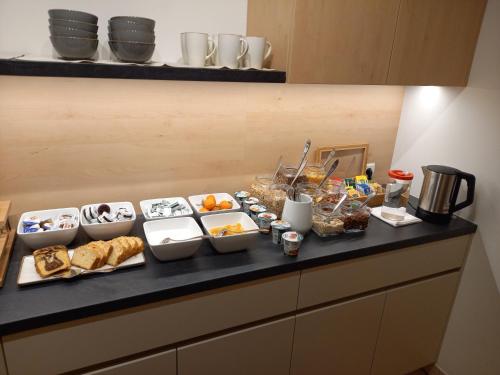 a buffet of food on a counter in a kitchen at Garni Sonnegg in Petersberg
