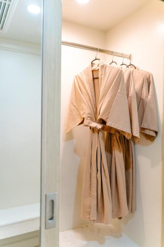 a dress hanging on a rack in a room at The Sea Cret Hua Hin in Hua Hin