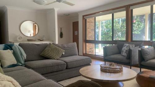 a living room with a couch and a table at Hawks Nest's Holiday Gem in Hawks Nest