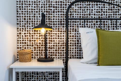 a bedroom with a bed and a lamp on a table at Beachfront Villa Alexandra in Skala Kefalonias