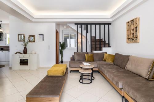 a living room with a couch and a table at Beachfront Villa Alexandra in Skala Kefalonias