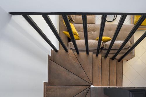 a stairway with black railings and a wooden railing at Beachfront Villa Alexandra in Skala Kefalonias