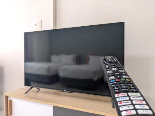 a remote control sitting on top of a television at ESLEAD HOTEL Osaka Tsuruhashi in Osaka