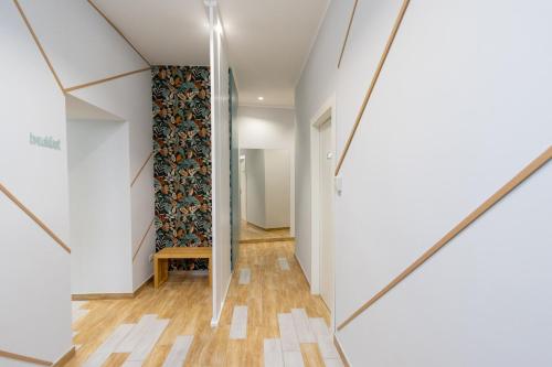 a hallway with white walls and wood floors and a staircase at B&B Sylvie in Sora