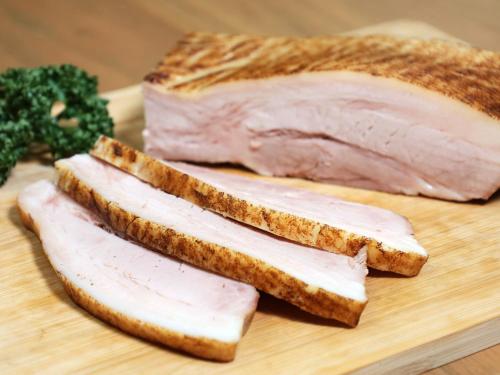 three pieces of meat on a cutting board with bread at Hotel Elcient Osaka Umeda in Osaka