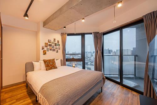 a bedroom with a bed and a large window at Zaito Tokyo East Mukojima APT in Tokyo