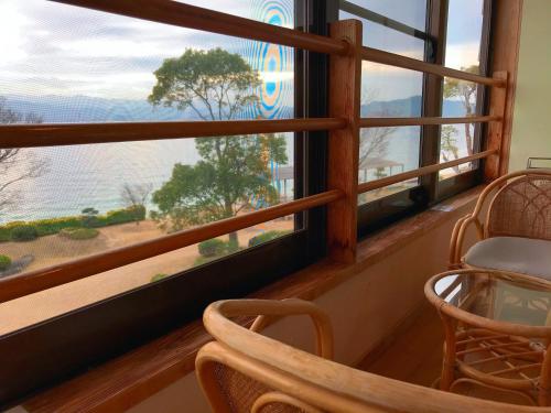 a room with a window with a view of the water at Sennenmatsu in Imabari