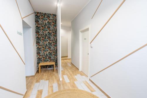a hallway with a wall mural and a mirror at B&B Sylvie in Sora