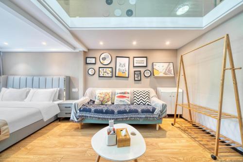 a hotel room with a bed and a couch at Plesant Daily Rental Apartment in Hangzhou