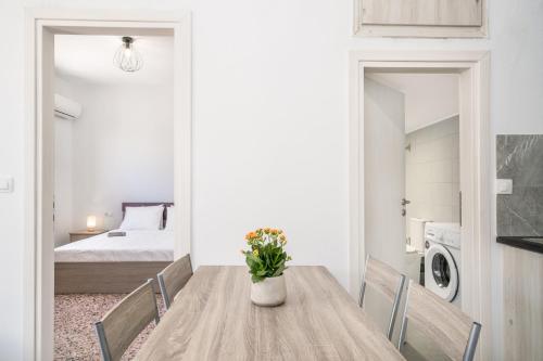 a dining room with a table and a bedroom at Patima Hills in Chania Town