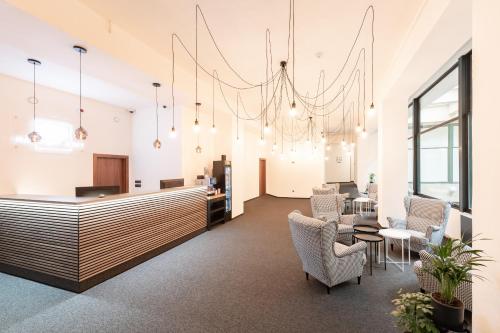 an office lobby with a reception desk and chairs at Narodni Stay in Prague