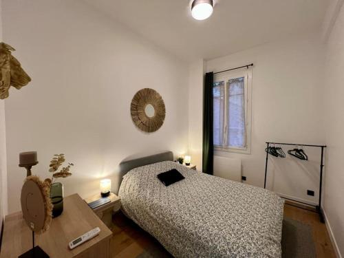 une chambre avec un lit, une table et une fenêtre dans l'établissement Les Orangers - 3 Pièces avec terrasse arborée, à Nice